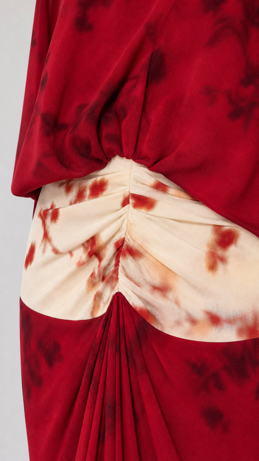 Close-up detail of the red tie-dye skirt waistband and top hem