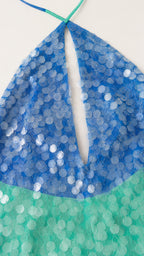 Close-up detail of blue and green sequins and keyhole neckline