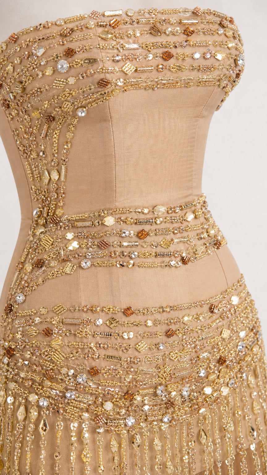 Close-up detail of metallic beading and sequins on the bodice
