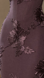 Close-up of dimensional floral embroidery on burgundy dress
