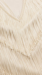 Close-up detail of V-neckline and fringe texture