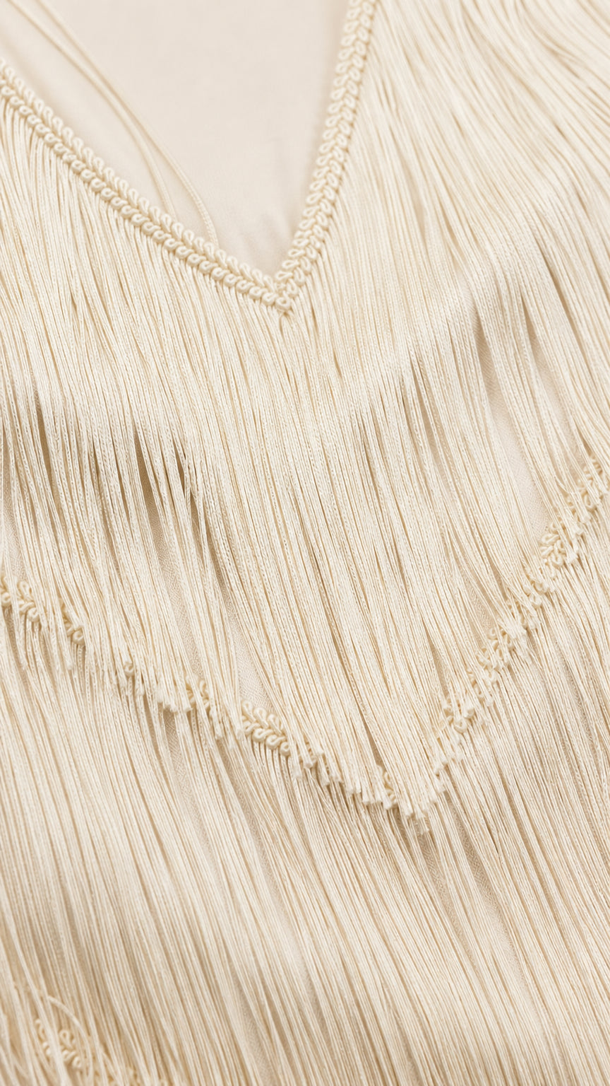 Close-up detail of V-neckline and fringe texture