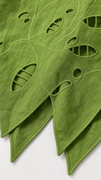 Close-up detail of fabric cutout pattern and hem