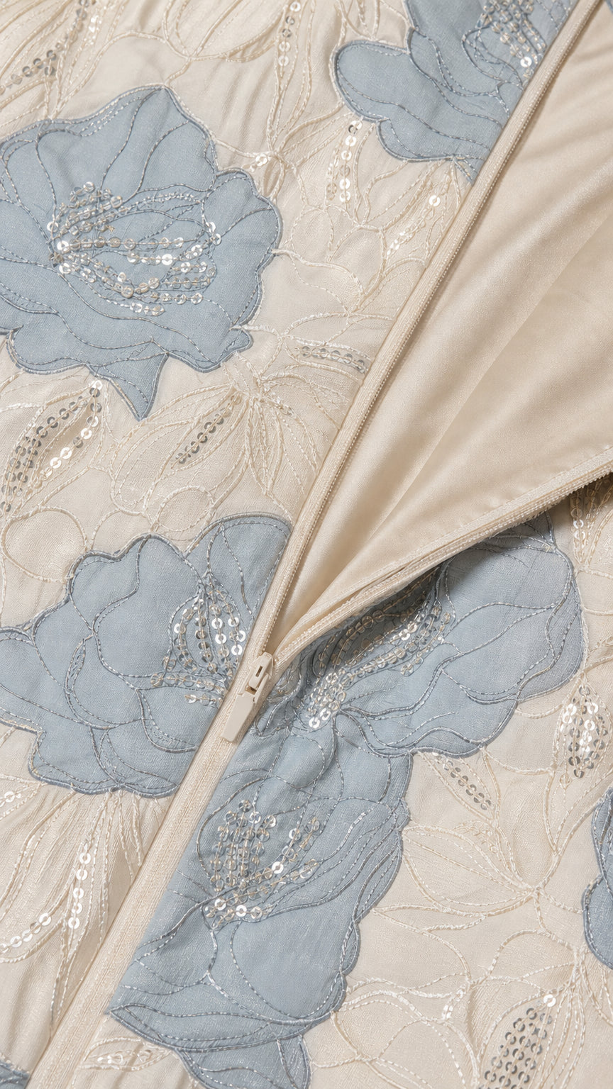 Close-up detail of floral embroidery, sequins, and side zipper