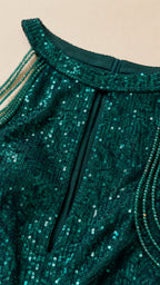 Close-up of emerald green sequin neckline and beaded straps
