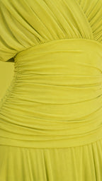 Close-up detail of the ruched bodice and pleated skirt in lime