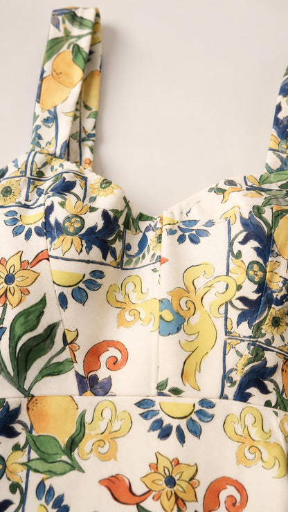 Close-up detail of straps and square neckline on white floral dress