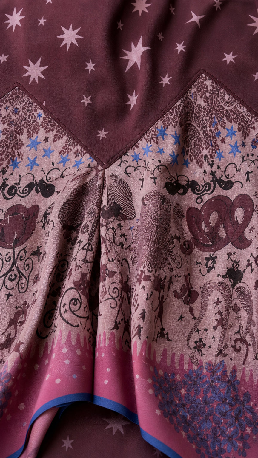 Close up fabric detail showing star print and asymmetric hem pattern