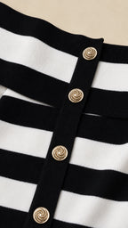 Close-up detail of gold-tone buttons on the striped knit dress