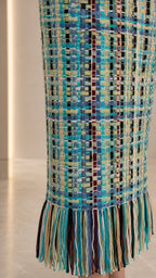 Close-up detail of tweed texture and fringe hemline