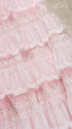 Close up texture view of pink tiered lace fabric