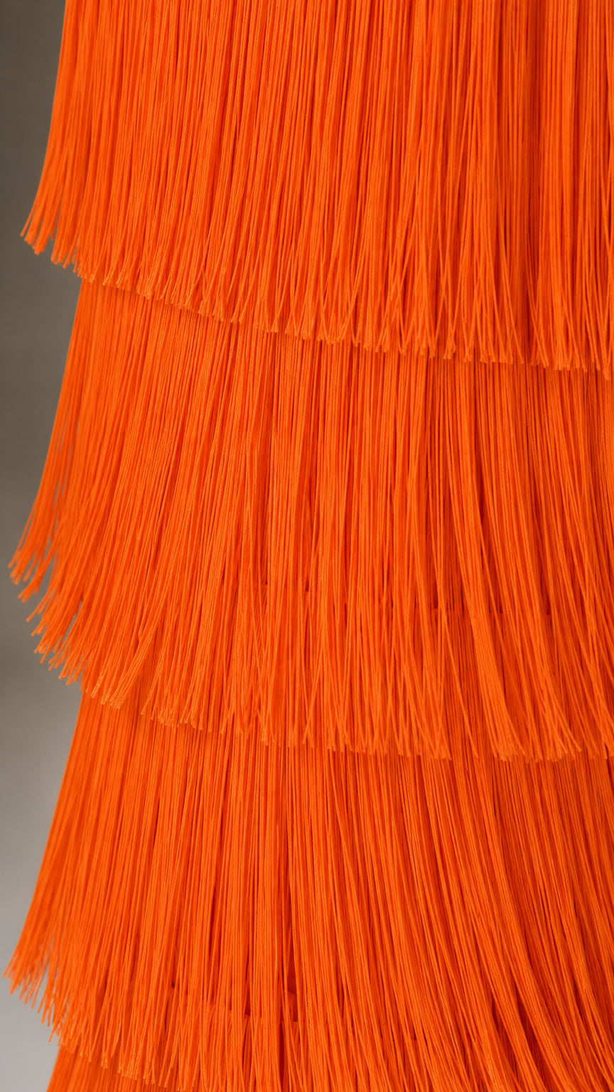 Close-up of textured multi-layered orange fringe detail