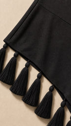 Close-up of asymmetrical tassel hem detail