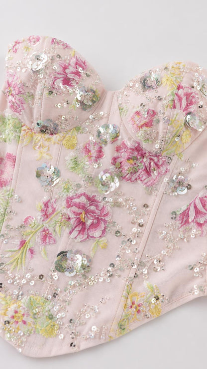 Close-up detail of sweetheart neckline and sequin floral embroidery