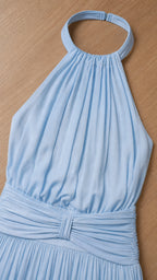 Close up of halter neckline and pleated bodice detail in light blue