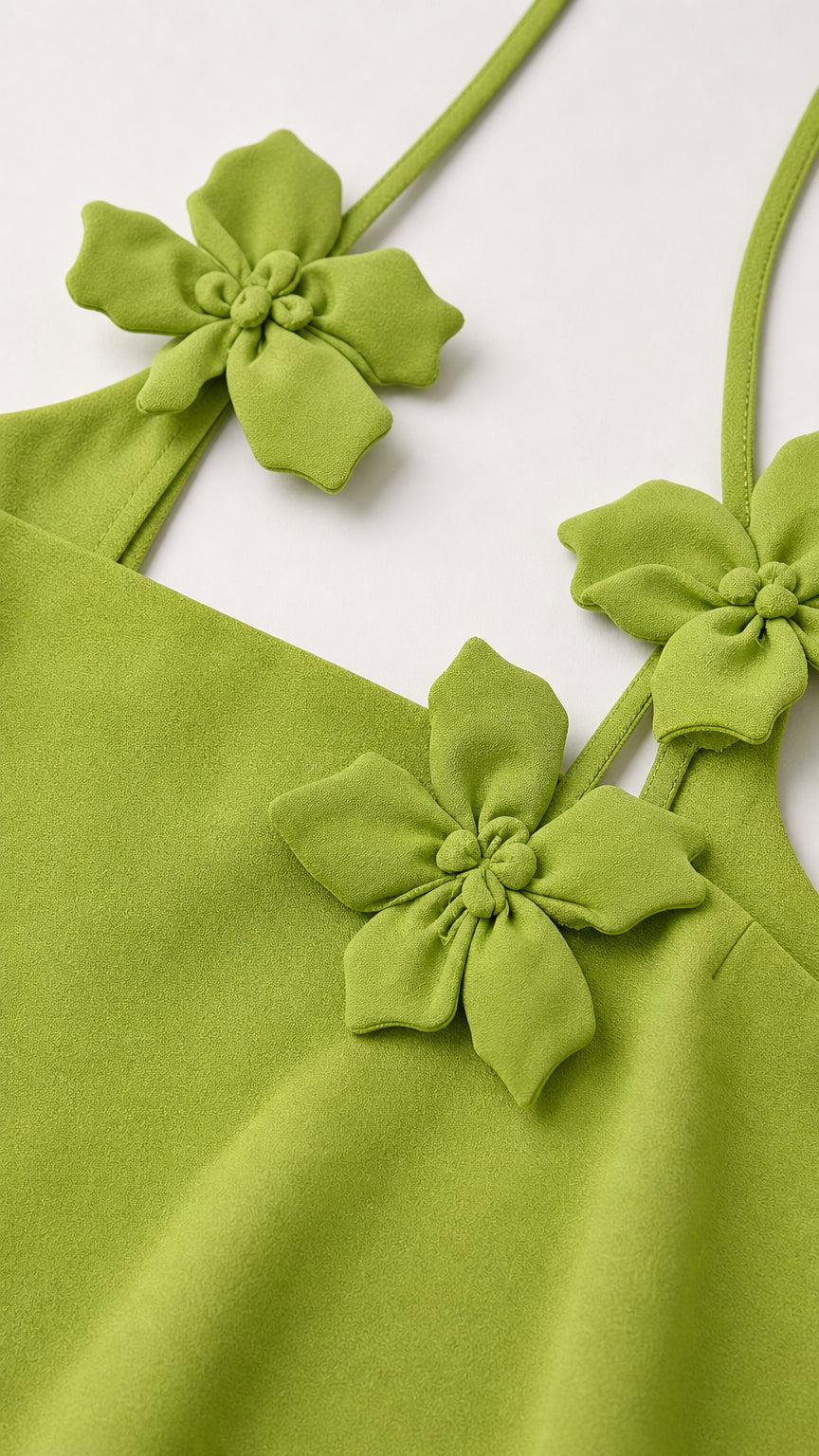 Close up of floral appliques and straps on tank top