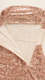 Close-up of structured corset boning and zipper detail on Rose Gold dress