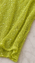 Close-up texture of lime sequin mesh fabric