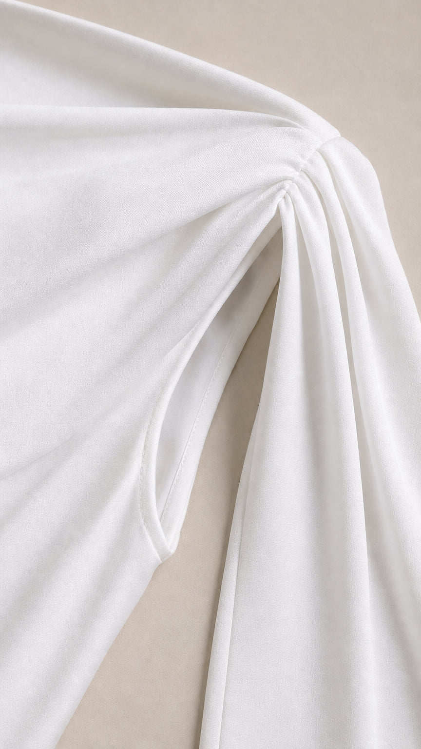 Close-up of the smooth fabric texture and shoulder ruching detail