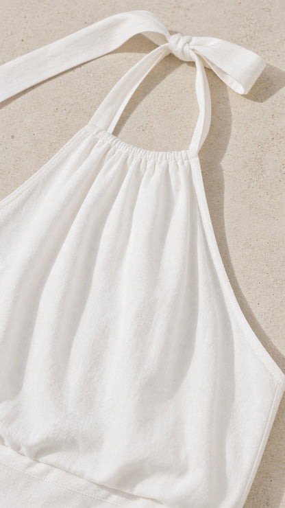 Close-up of the gathered halter neck and tie detail in white