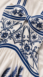 Close-up detail of the bodice, straps, and cutout on the white dress