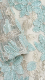 Close-up detail of mint floral embroidery and sequins