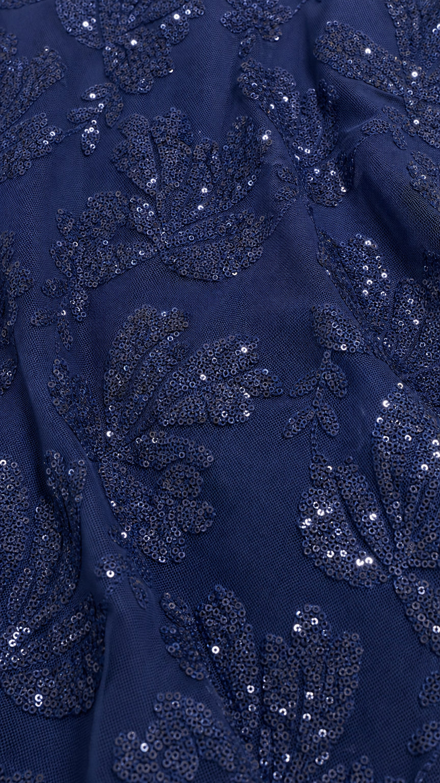 Close-up detail of navy sequin and lace embroidery