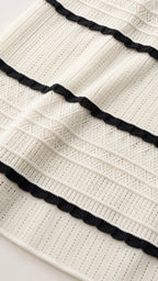Close-up detail of white and black striped ribbed knit fabric