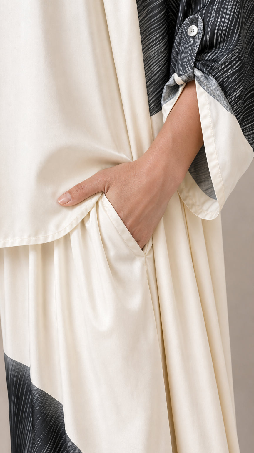 Close-up of pocket detail on off-white wide-leg trousers