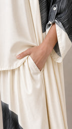 Close-up of pocket detail on off-white wide-leg trousers