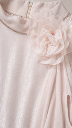 Close-up detail of the mock neckline, rhinestone trim, and 3D floral appliqué