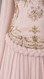 Close-up detail of gold embroidery and braided trim on bodice