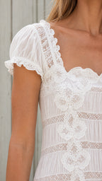 Close-up of lace bodice and square neckline on white maxi dress