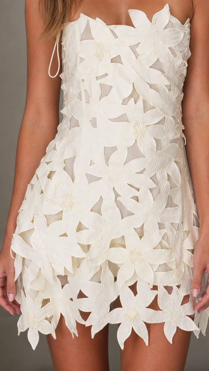 Close-up detail of white 3d floral dress texture and hem