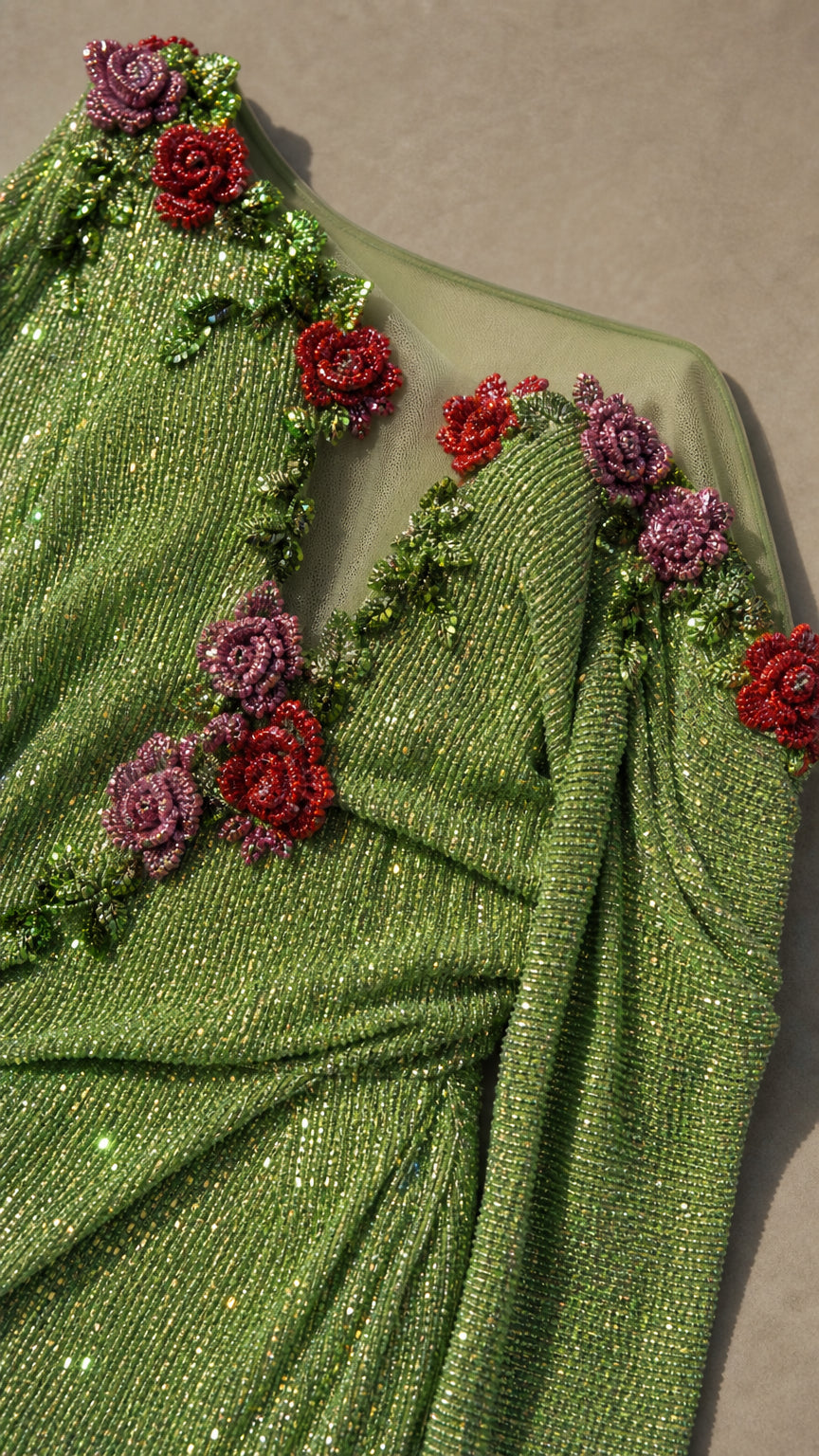 Close-up of 3D beaded rose appliques on green evening dress