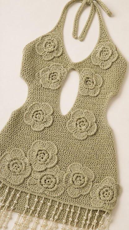 Close up of crochet floral pattern and beaded fringe hem