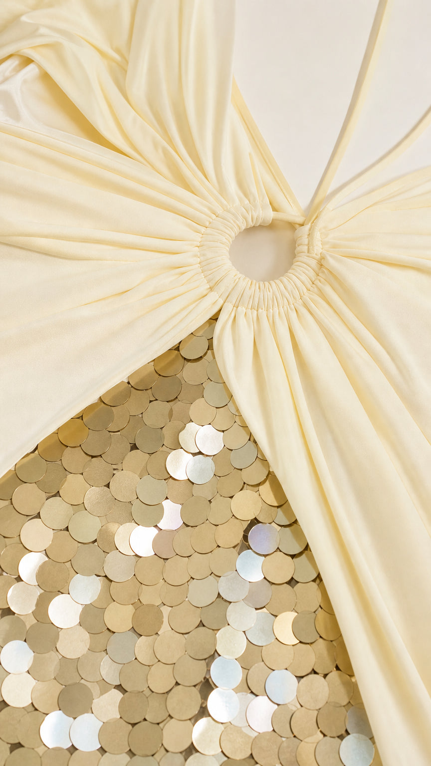Close-up detail of ring hardware and gold sequins