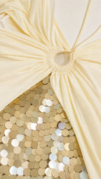 Close-up detail of ring hardware and gold sequins