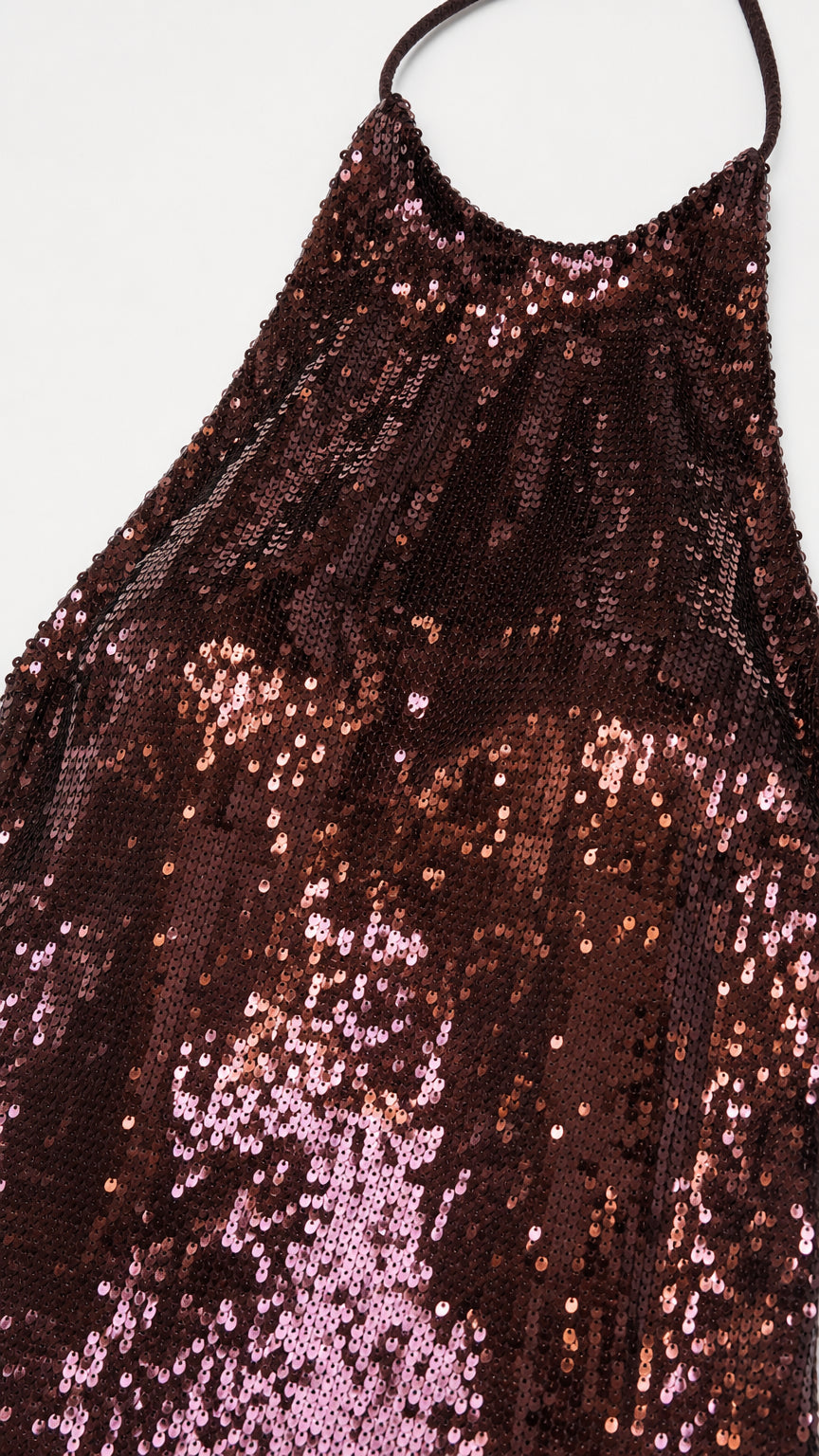 Close-up texture view of brown sequin fabric and halter strap