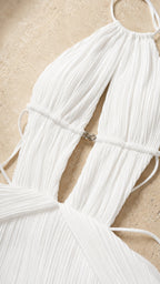 Close-up detail of halter neckline and cutout hardware on white dress