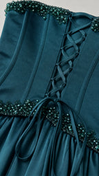Close-up of beaded neckline and lace-up back construction