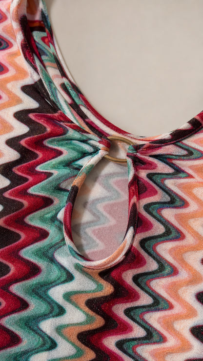 Close-up detail of neckline, ring, and cutout on chevron dress