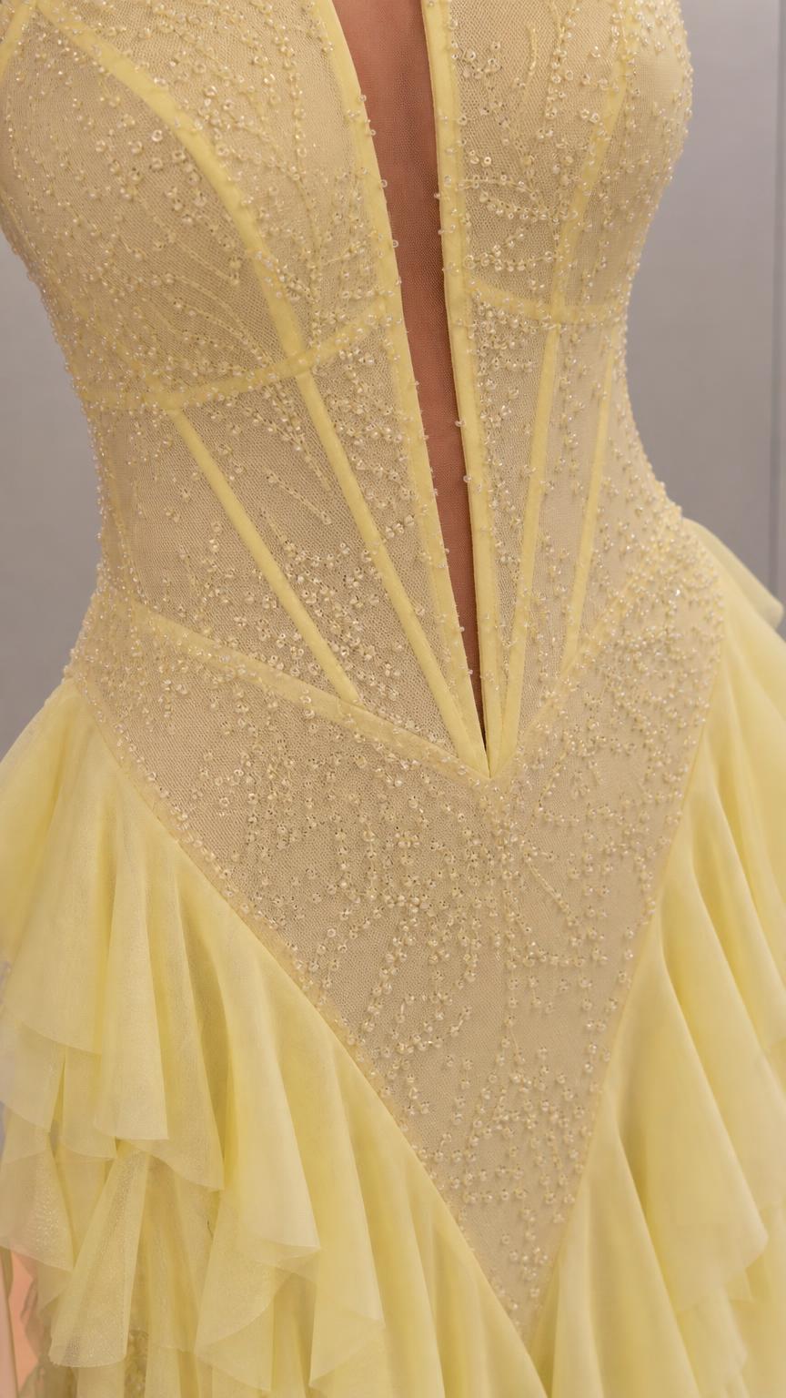 Close-up of intricate bodice beading and deep V-cut on yellow dress