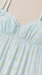 Close-up detail of scalloped V-neckline and micro-floral print