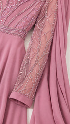 Close-up of intricate bodice beadwork and mesh sleeve