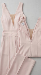 Detailed flat lay of blush pink jumpsuit construction and zipper