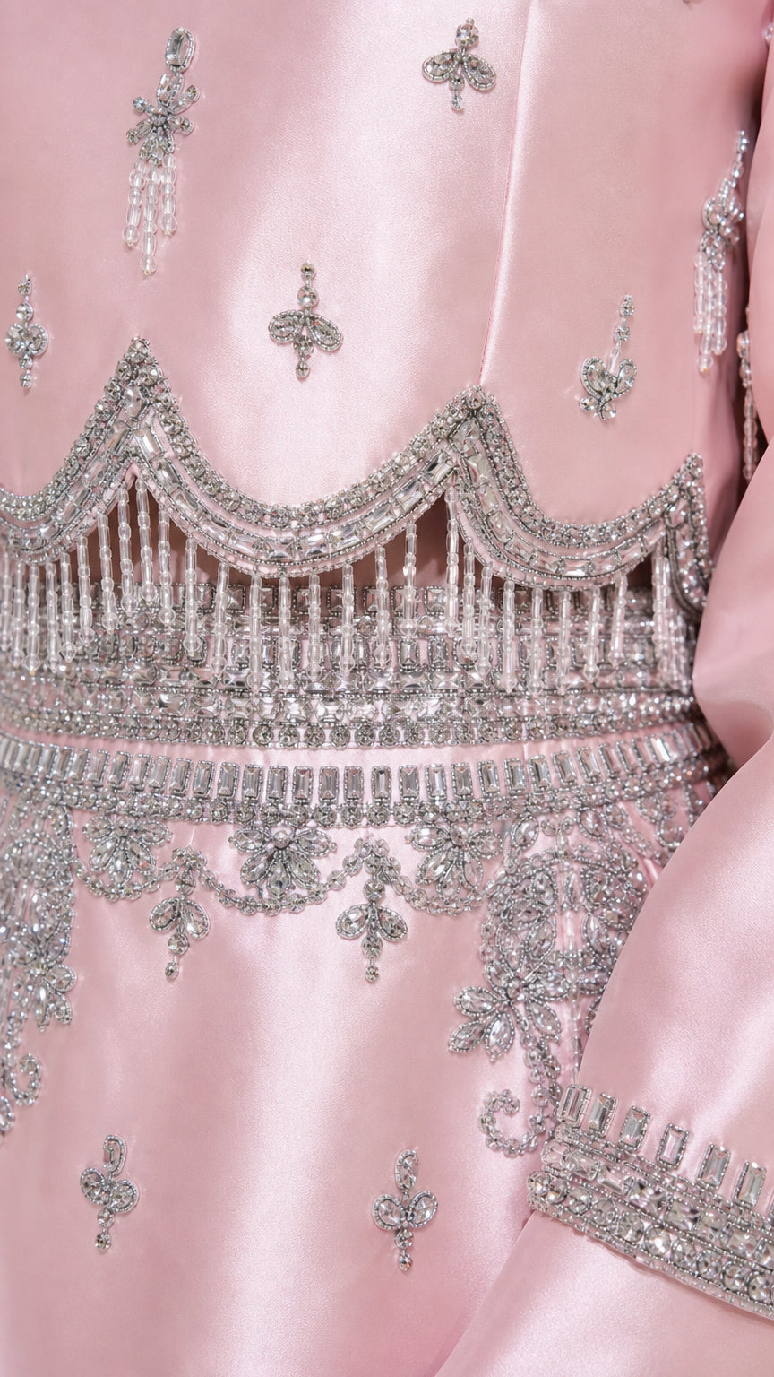 Close-up detail of silver beadwork on pink satin dress