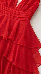 Close-up detail of red chiffon ruffles and ruched waistband