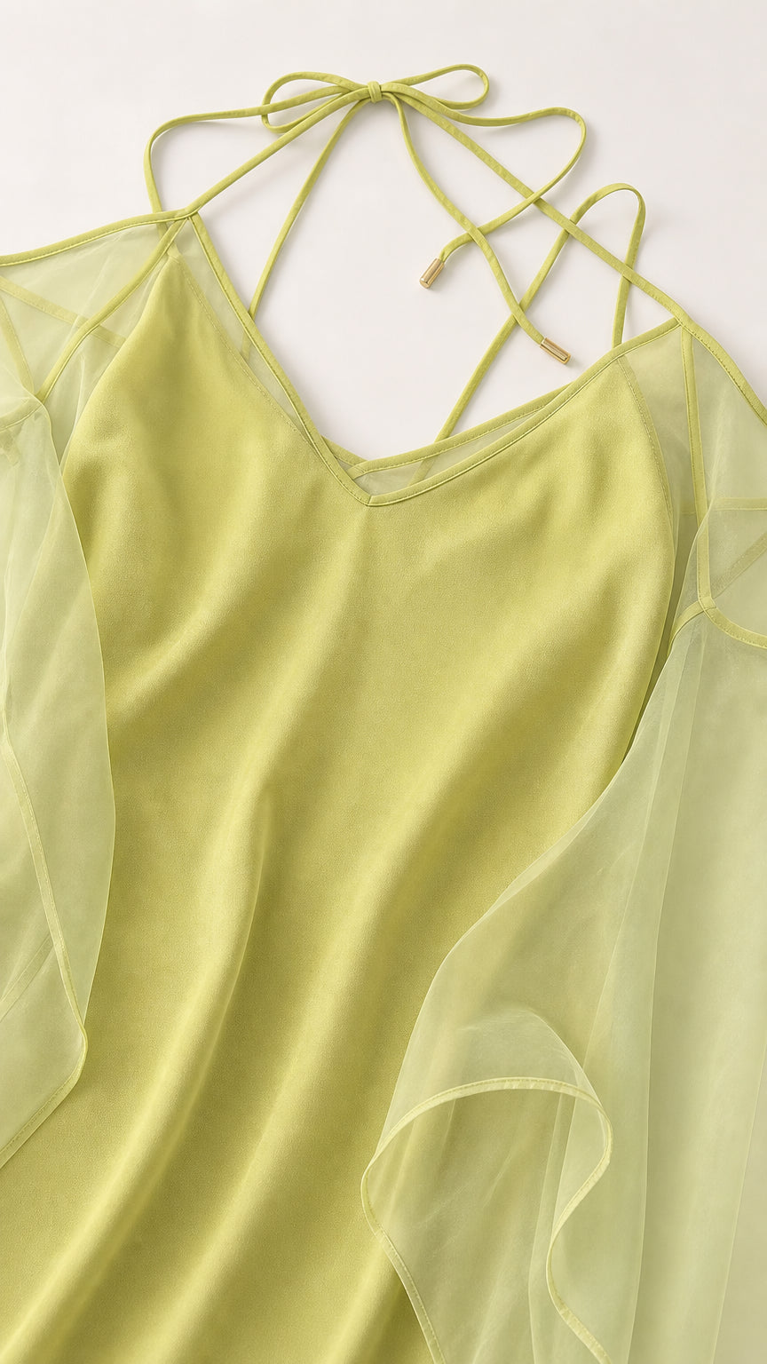 Close-up of V-neck and delicate strap details on lime dress