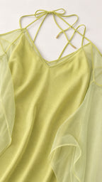 Close-up of V-neck and delicate strap details on lime dress